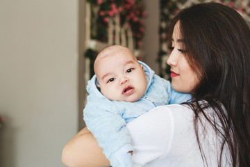 Portrait of a happy young Japanese or Asian mom and her baby