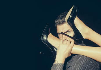 Legs of woman in shoes at man with beard.