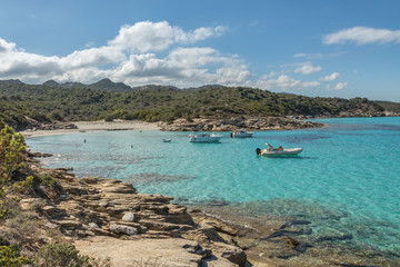Boats in a small cove with sandy beach in Corsica