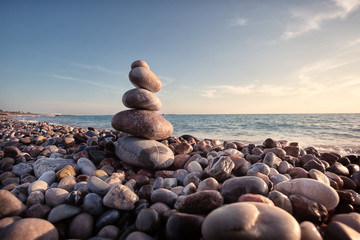 Pyramid of stones against the background of the sea