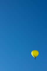 Fototapeta premium Yellow hot air ballon on blue sky.