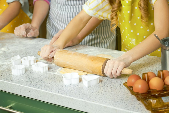 Hands of child rolling dough. Preparation of pastry. Easy pie recipes.