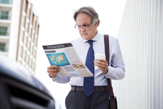 Man reading newspaper at outdoor
