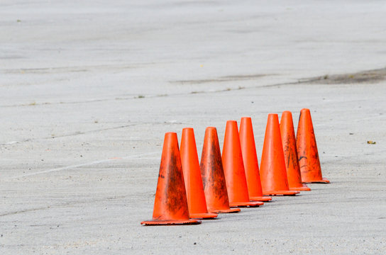 Eight traffic cones in a line on an empty parking lot, made during course setup for an SCCA Solo event at Oak Mountain Amphitheater in Birmingham, Alabama, USA