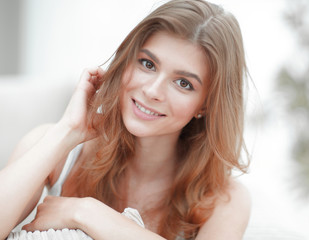 closeup portrait of a smiling young woman with light make-up