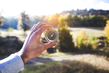 young man hand compass