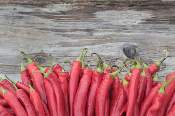 Red Hot Chili Peppers Pile Freshly Picked Organic Harvest Wooden Background. Mexican Food Concept Copy Space