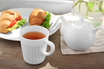 Cup of tea and croissants on windowsill
