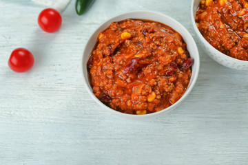 Bowl with delicious chili con carne on table