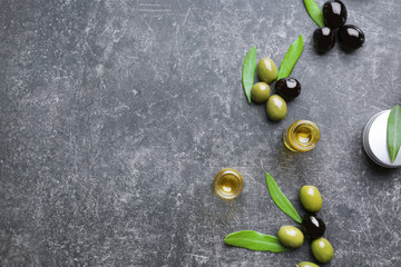 Composition with olive oil and cosmetics on grey table