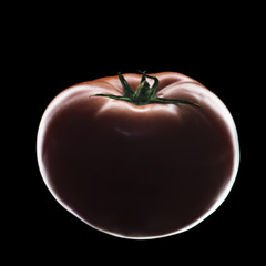 Elegant red tomato on a black background isolate