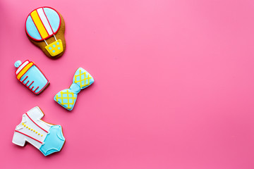 Cook gingerbread cookies for baby shower on pink background top view mockup