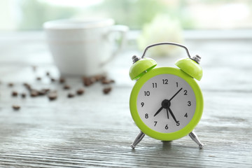 Alarm clock on wooden window sill. Morning routine concept
