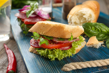 Delicious sausage sandwich on wooden board