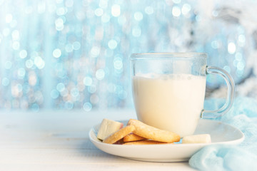Glass mug of hot milk with cookies