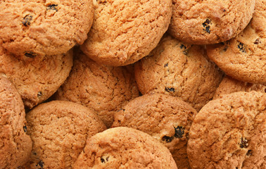 Many delicious oatmeal cookies with raisins, closeup
