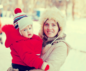 Fototapeta premium happy mother with toddler in winter