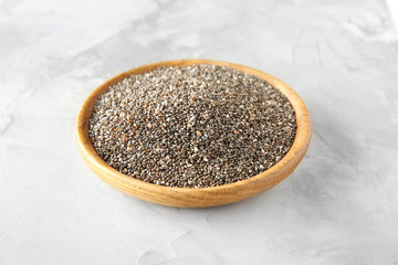 Bowl with chia seeds on table