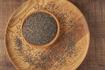 Dish and bowl with chia seeds on table