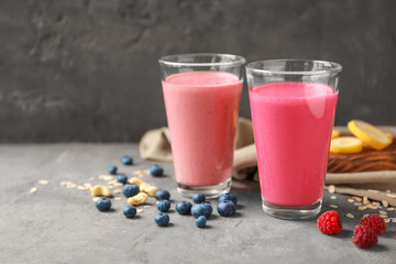 Glasses with berry protein shakes on table