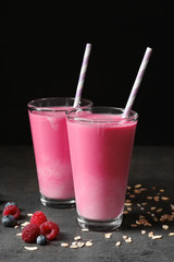 Glasses with berry protein shakes on table