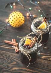 Two glasses of mulled wine on the wooden background