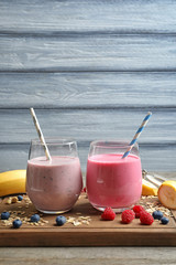 Glasses with berry protein shakes on board