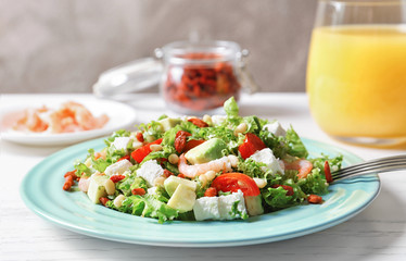 Plate with delicious goji berry salad on table, closeup