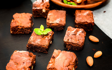 chocolate brownies on dark wooden background, top view