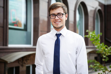Fototapeta premium Attractive young man in formal wear on city street
