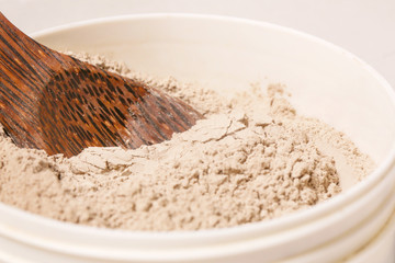 Cosmetic clay powder in the plastic container