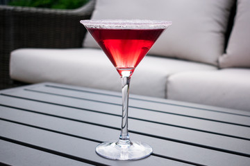 Martini glass with cold drink in outside background 