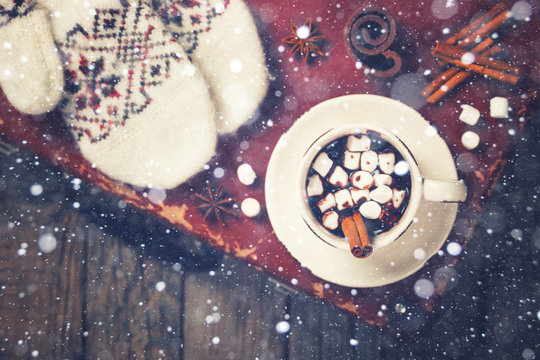 Hot Chocolate with Marshmellow candies. Warming holiday drink with cinnamon sticks . Warm Christmas.Winter Still Life in the Cup.Toned image Vintage style