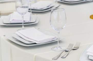 Beautifully decorated table for a celebration in a restaurant in white colors.
