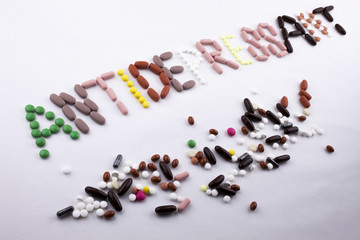 Hand writing text caption inspiration Medical care concept written with pills drugs capsule word Antidepressant On white isolated background with copy space