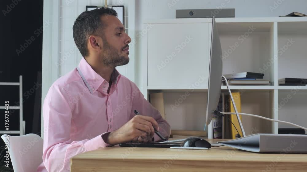 Aufkleber mixed race handsome designer working in modern creative office. Young man sitting in front of display computer drawing using digital tablet