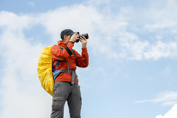 Picture of man photographer with camera and backpack