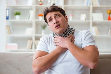 Young man suffering from sore throat