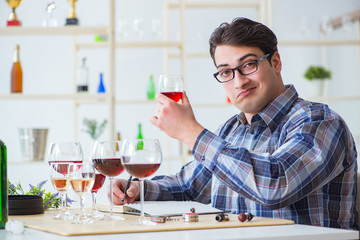 Professional sommelier tasting red wine 