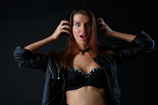 Image of young model in headphones with leather jacket