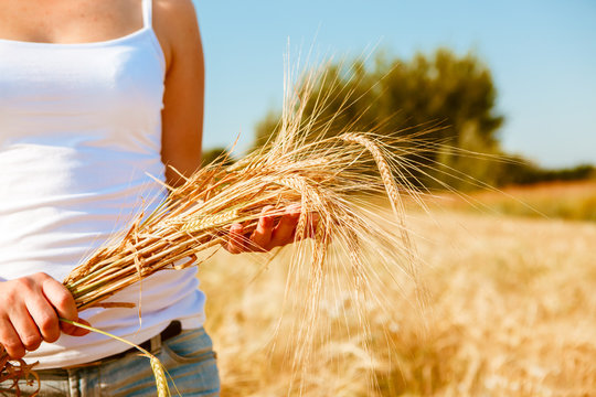 Photo of girl in white T-shirt with spikelets