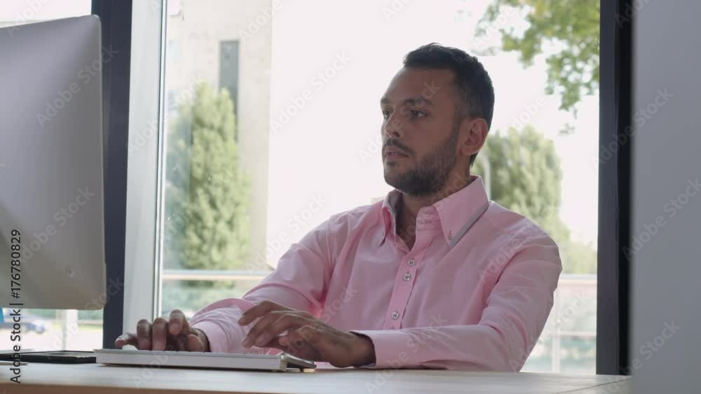 Aufkleber portrait mixed race man working at home office. adult man typing on keyboard looking on monitor comp