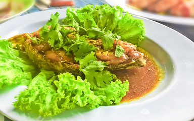 Thai food deep fried fish with herbs and fish sauce