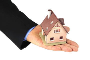 House in hands on white background.