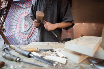 Wood craftsman with various hand tools working.