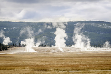 Unidentifiable tourists having an incredible time visiting a geyser basin on Yellowstone National Park