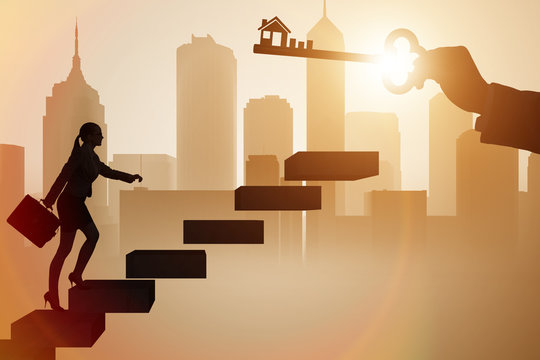 Businesswoman holding key in real estate concept - Powered by Adobe