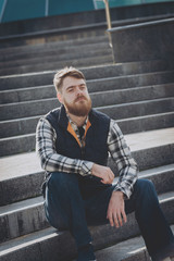 Handsome bearded man in casual clothes posing on camera