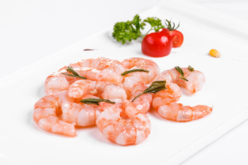 Roasted prawns on white plate on white background