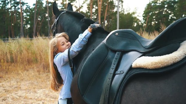 communication - young girl and bay horse in wood